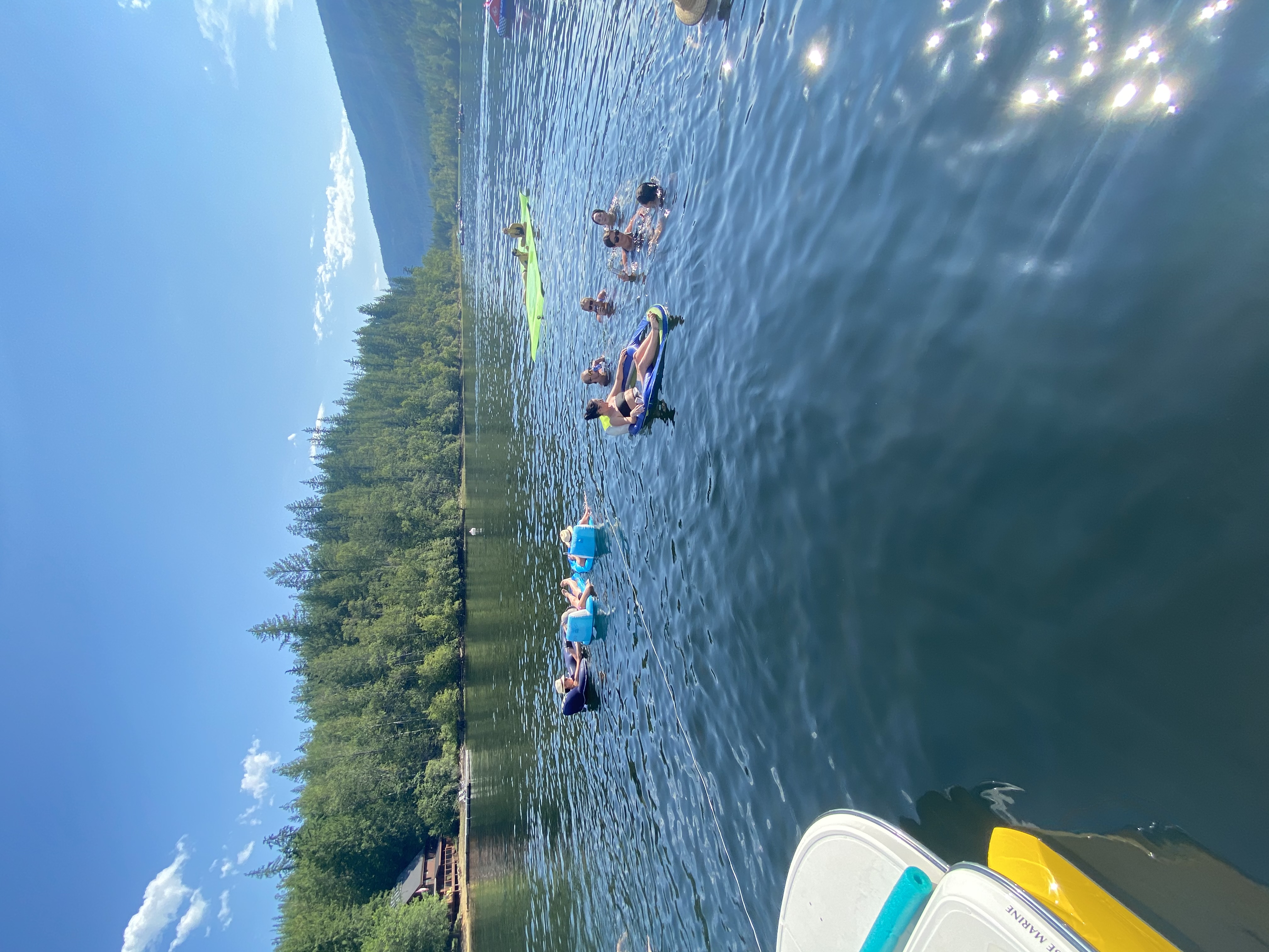Family and friends swimming and floating together on Mara Lake