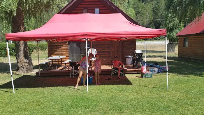 Family relaxing outside a cabin at Willow Shores Resort