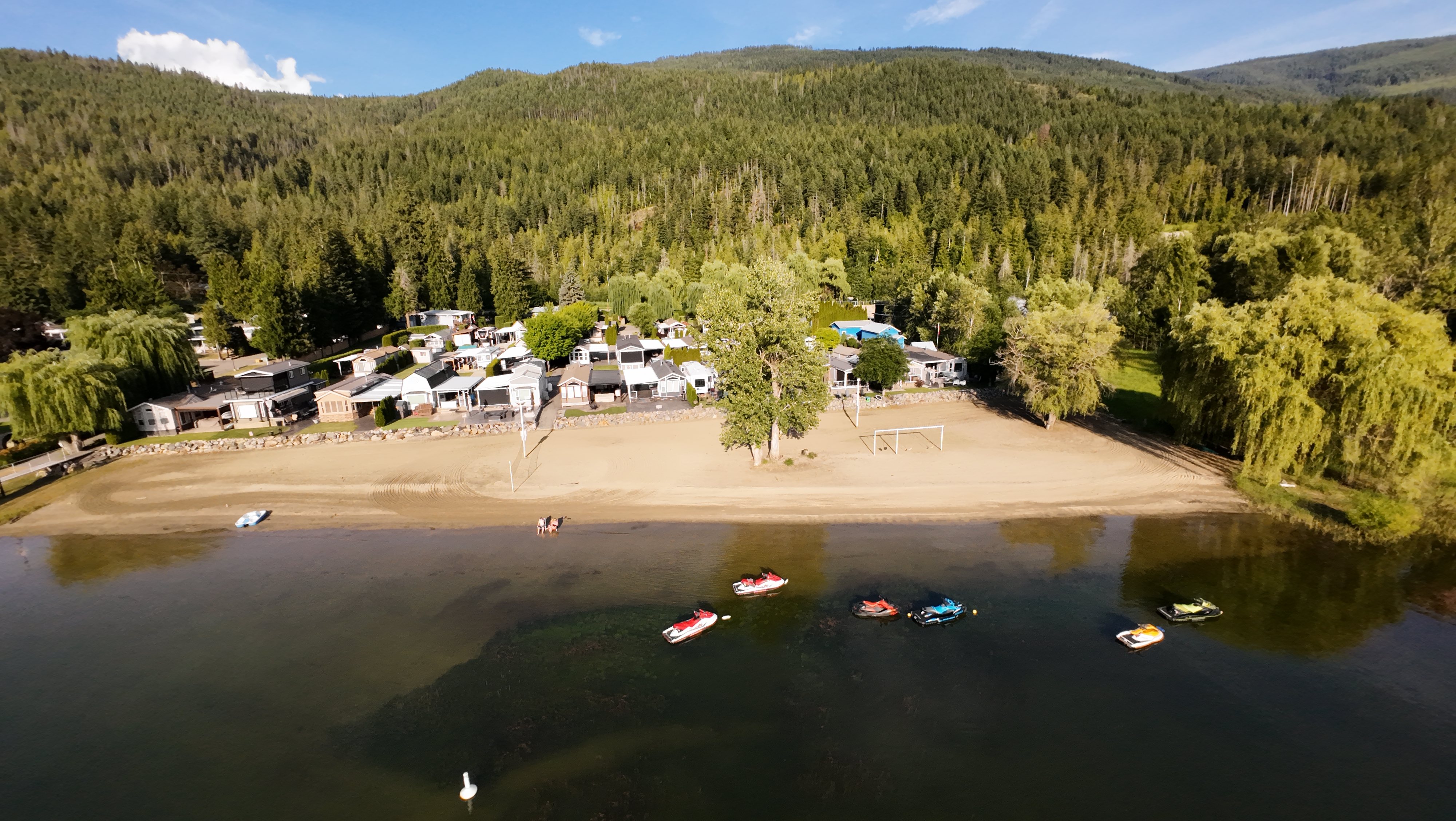 Aerial view of the private sandy beach and waterfront at Willow Shores Resort on Mara Lake